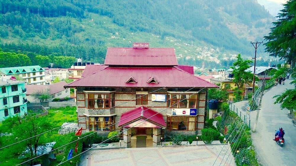 A sub-aerial view of the exterior of DLS Hotel Devlok, Manali with the mountains in the backdrop
