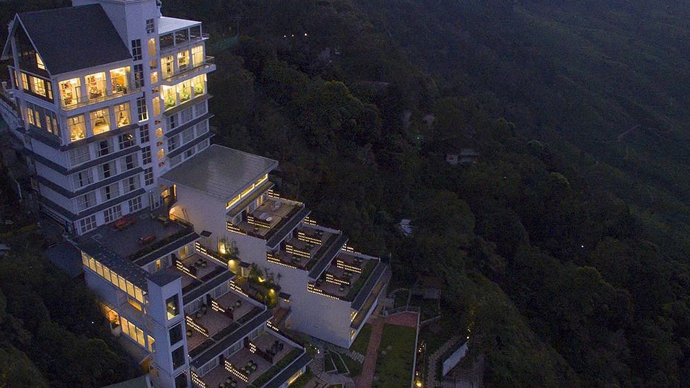 Facade view of Fragrant Nature Munnar illuminated at night