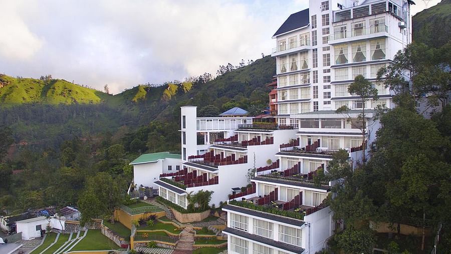 Facade view of Fragrant Nature Munnar, surrounded by majestic mountains