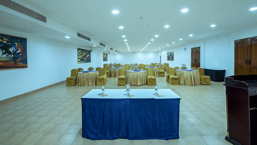 Orchid Hall set up with a head table and blue linen at Chariot Beach Resorts, ideal for conferences and formal business meetings.