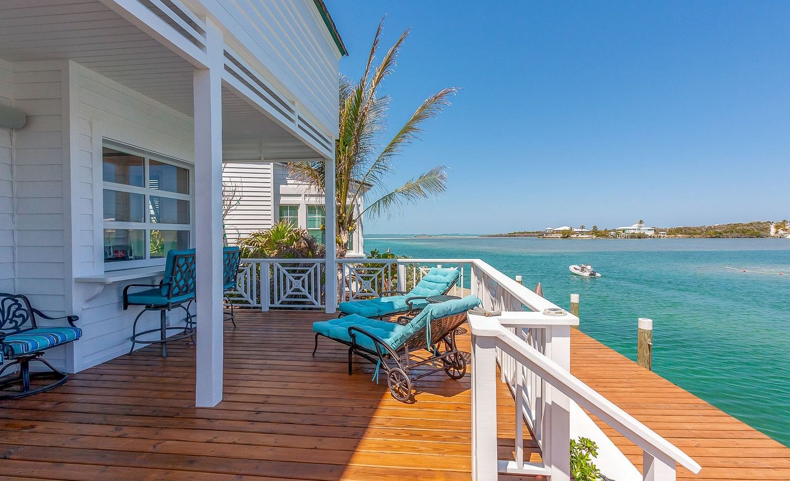 Covered porch with seating and views of calm turquoise waters | Abaco Inn
