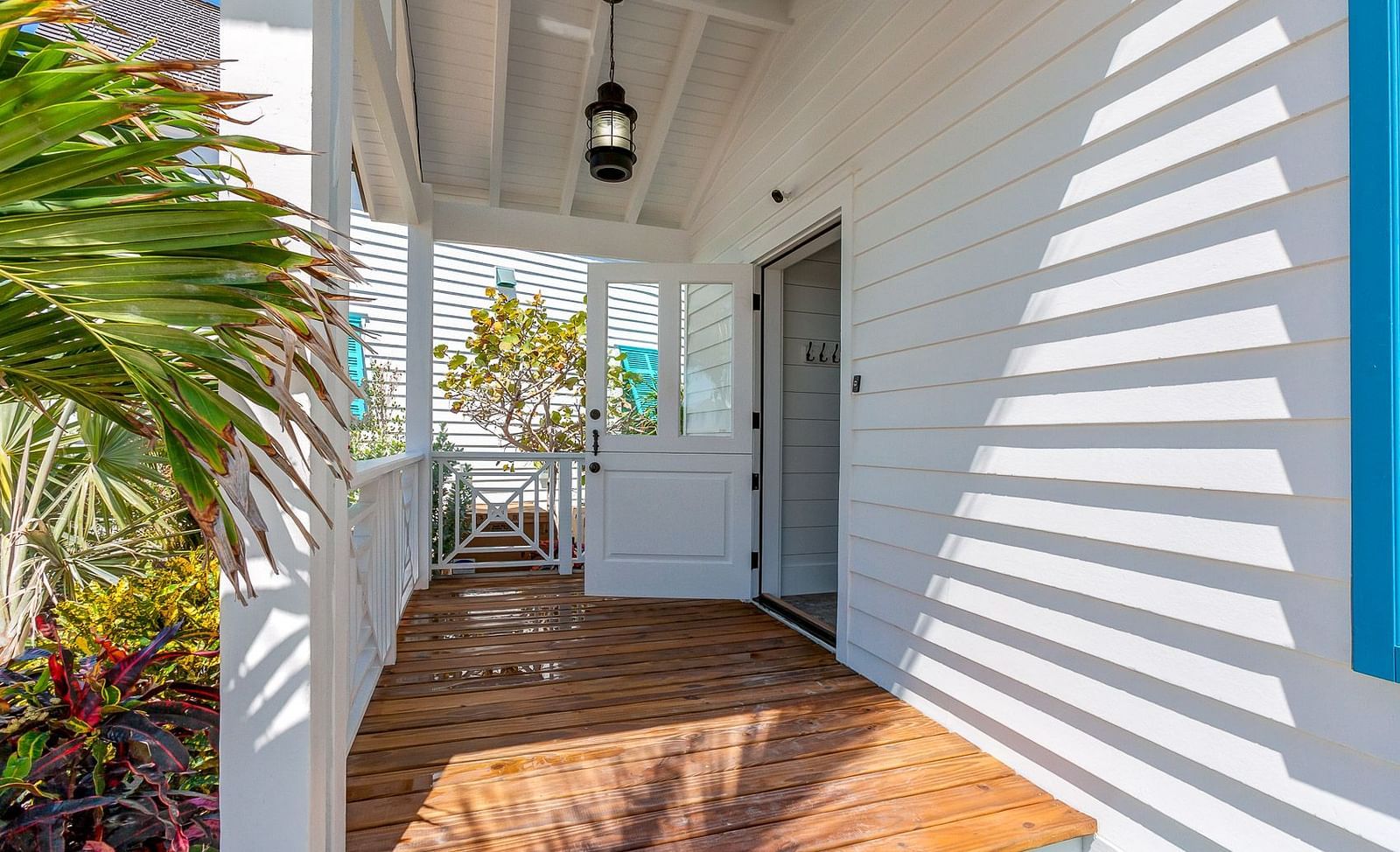 A porch with wooden flooring and white walls | Abaco Inn