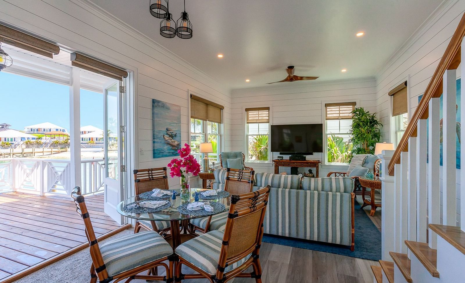 Dining area with glass doors opening to a deck with outdoor seating | Abaco Inn