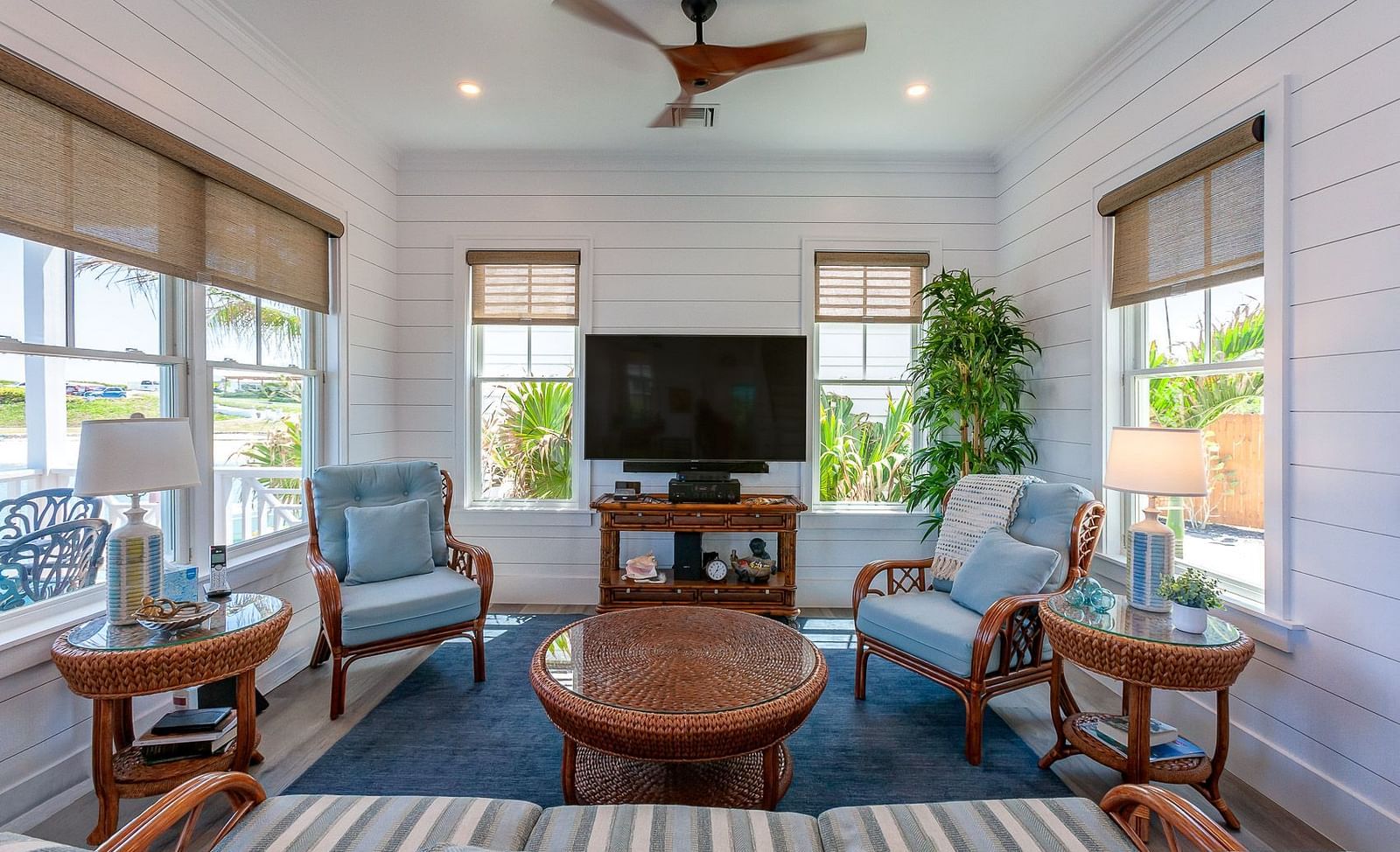 Bright living area with armchairs, a coffee table, and large windows | Abaco Inn