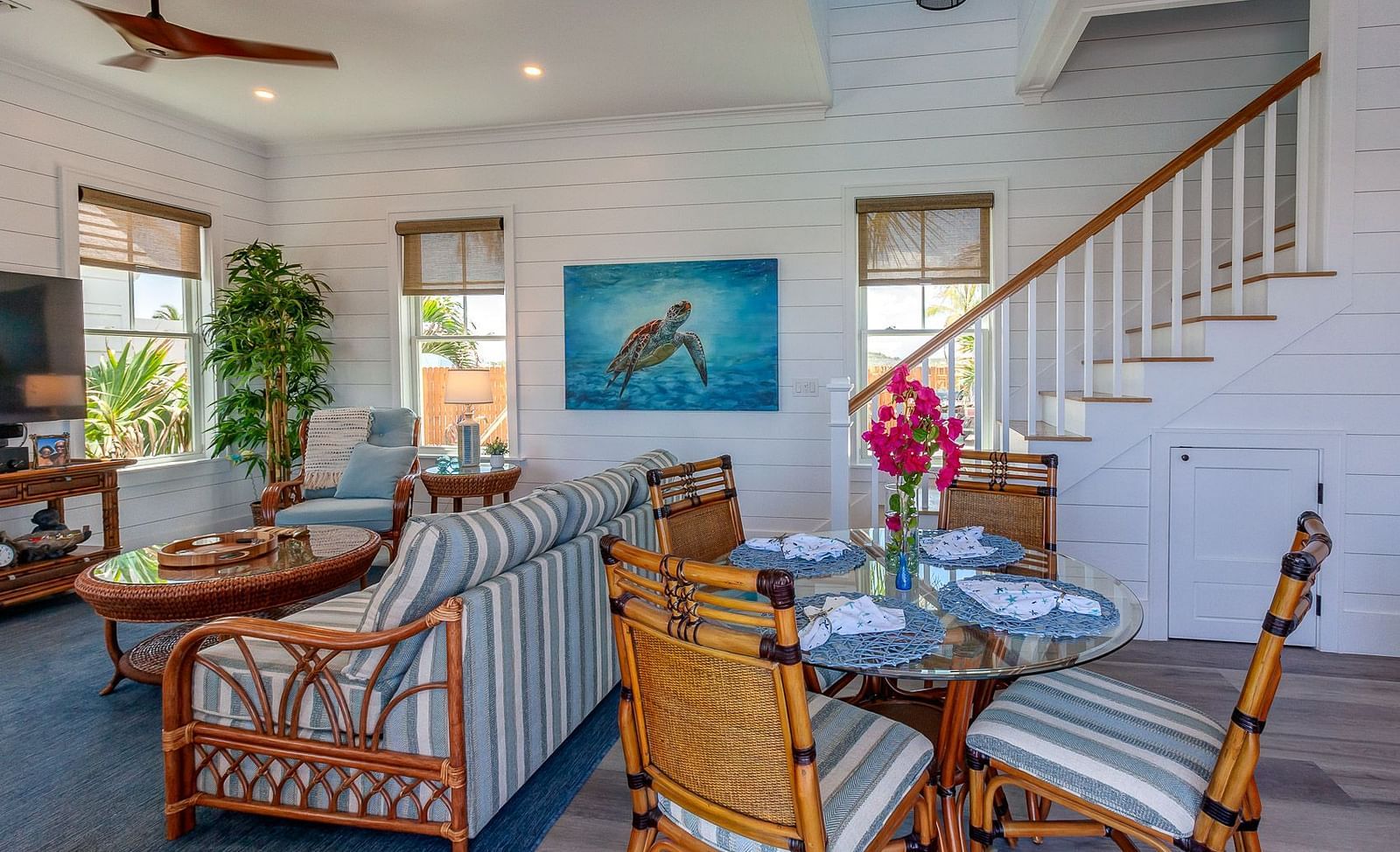 Open-plan living and dining area with wooden furniture and a staircase | Abaco Inn