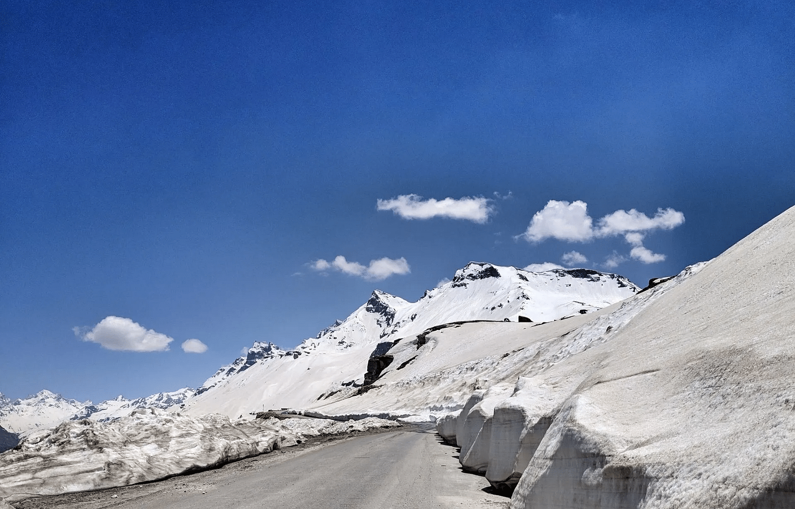 a view of the snowy mountains on a bright day