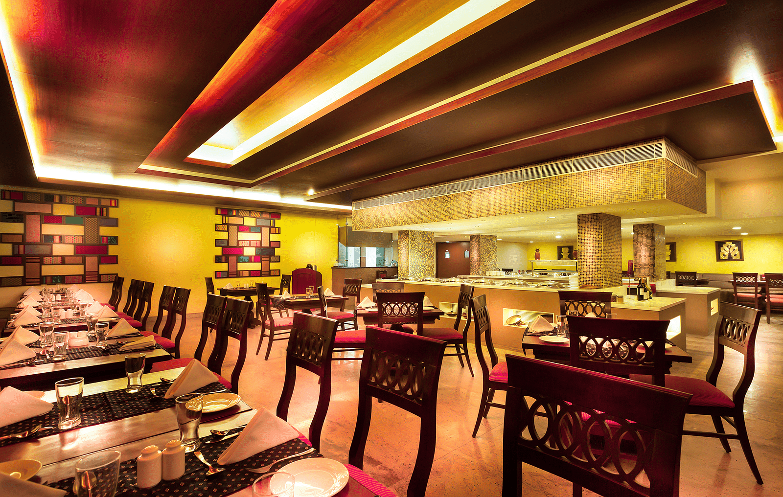 An image of a dining space with tables and chairs at Regency Madurai by GRT Hotels