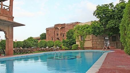 A pool side view of the facade of Fort Chanwa