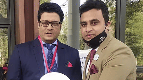 Hotel guest presenting an autographed plate to a staff member at Polo Towers Agartala Hotel.