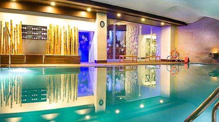 Swimming pool alongside the room at  Grand Chennai By GRT Hotels.