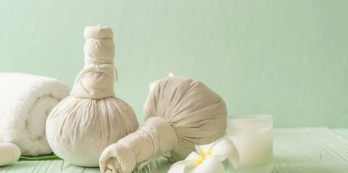 A set of poultices kept next to each other and a rolled towel near them