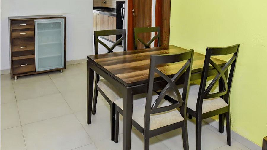 Side view of the dining area with a table and chairs at La Vida Studio Inn Goa.