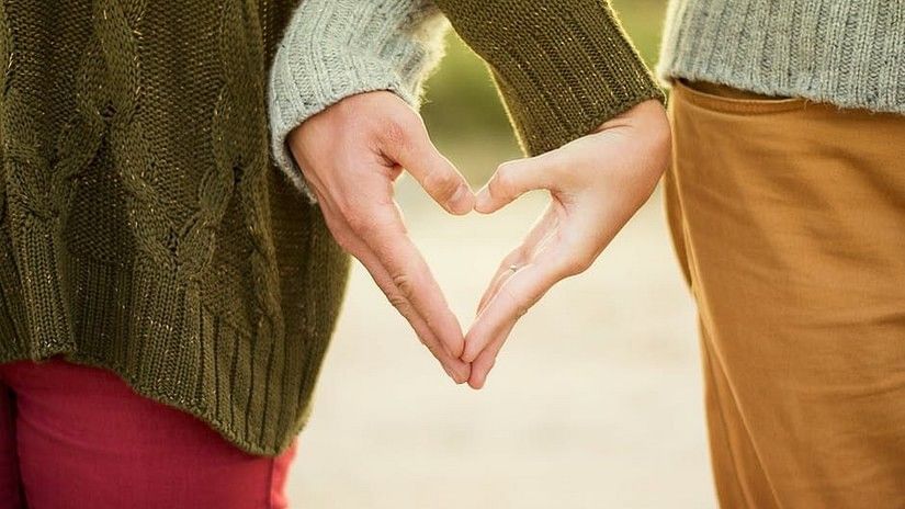 Couples making a heart shape and by hands