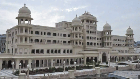 An ancient white palace or building with a large courtyard.