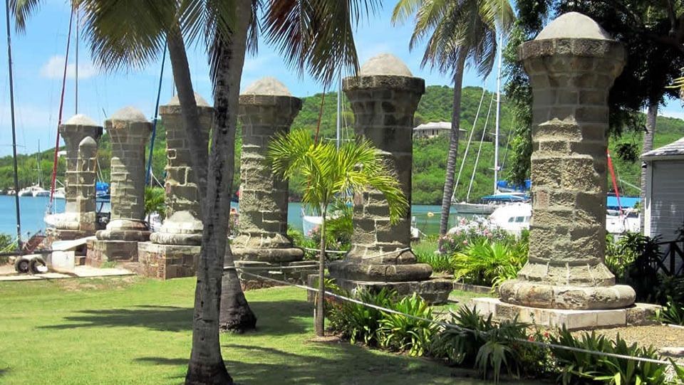 Historic ruins surrounded by palm trees.