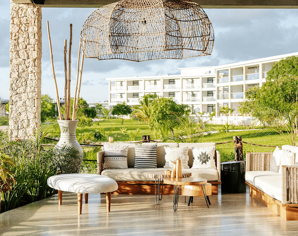 Image of an outdoor seating with sofas with tables in front
