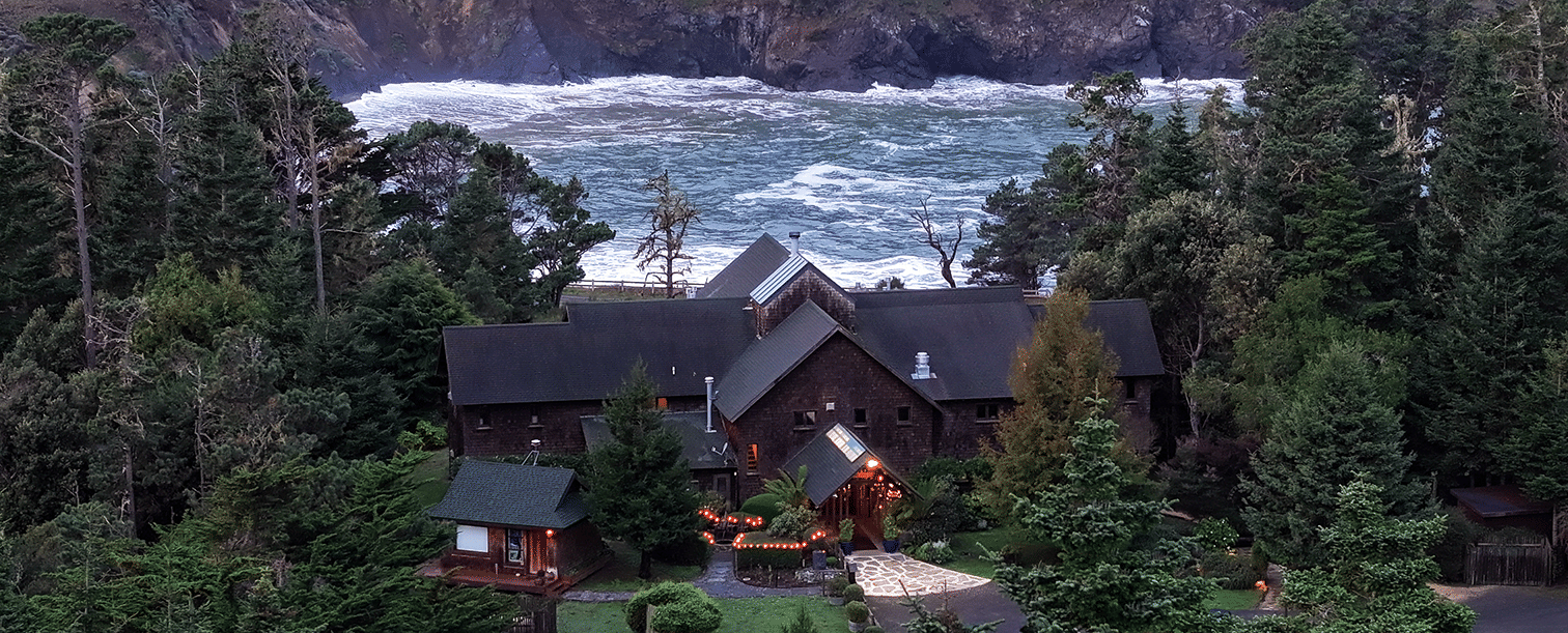 Waves of Mendocino coast crashing against the shore situated behind a hotel - Brewery Gulch Inn & Spa