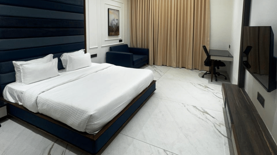Wide view of a modern king size bedroom with marble flooring - Lords Swastik Studio, Kodinar