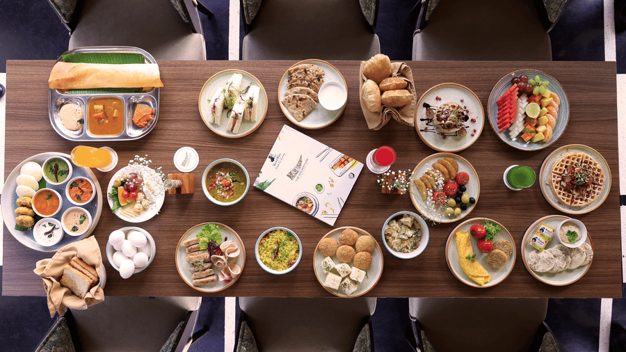 large dining table covered with numerous small plates of diverse food items  at The Golden Tusk, Jim Corbett