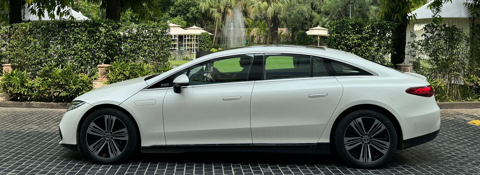 image of a white car parked in the driveway of The Claridges New Delhi