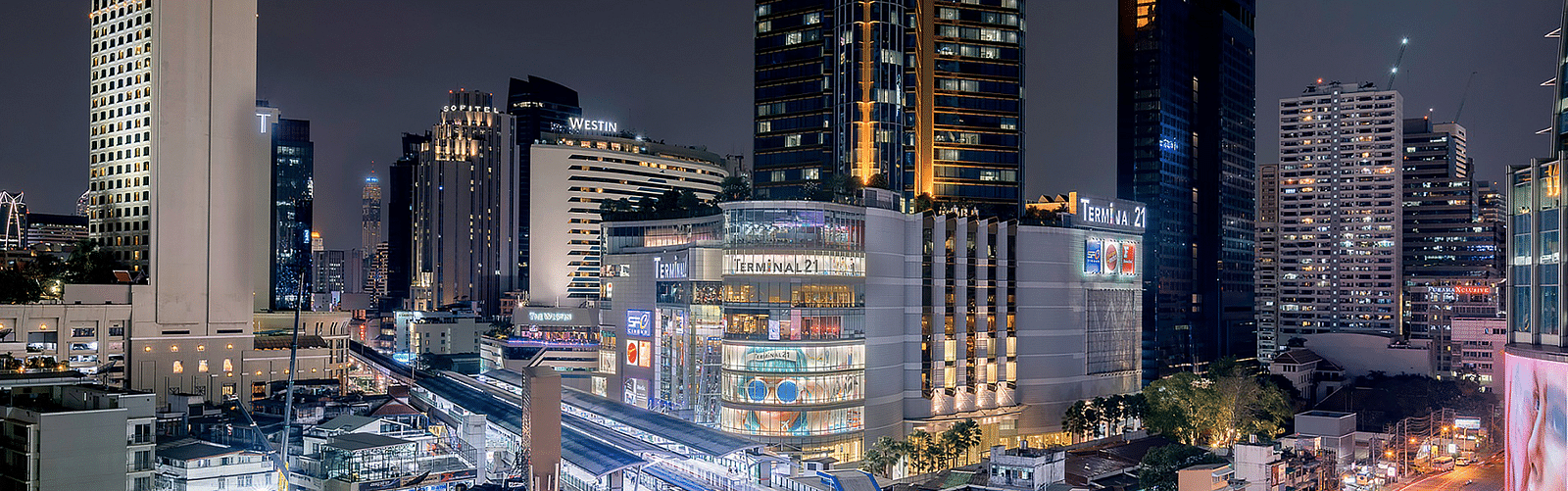 a wide angled view of Asok Montri Road at night