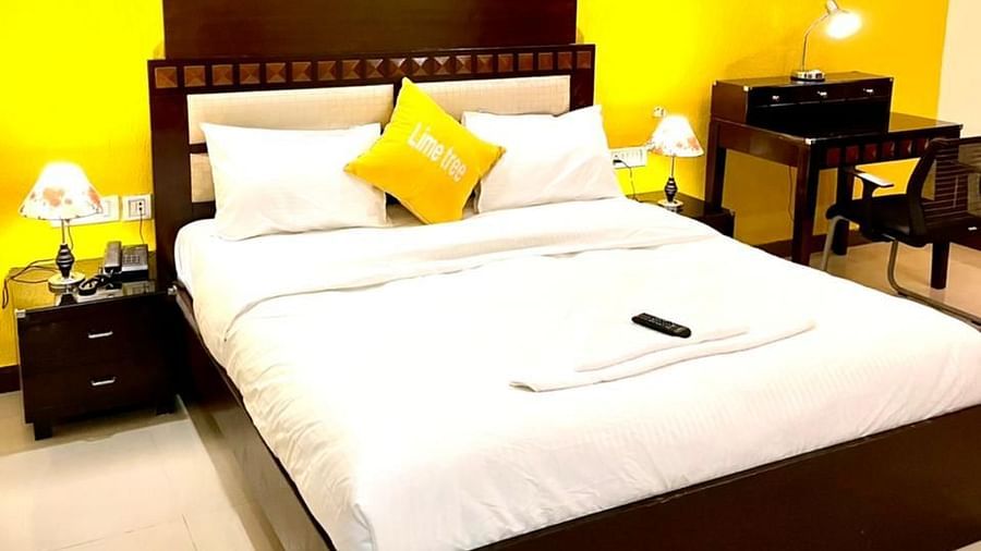 An image of a bedroom with king size bed, a bedside table with lamp and a seating area with table and chairs - Lime Tree, Greater Kailash - 2