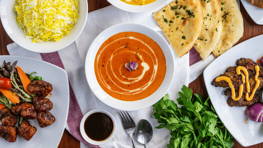A top shot of a delicious spread of various Indian dishes served on a table.