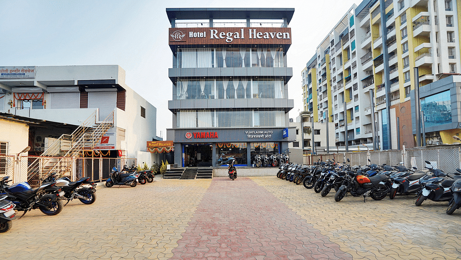 Facade of Hotel Regal Heaven, Pune with parking area in the front.