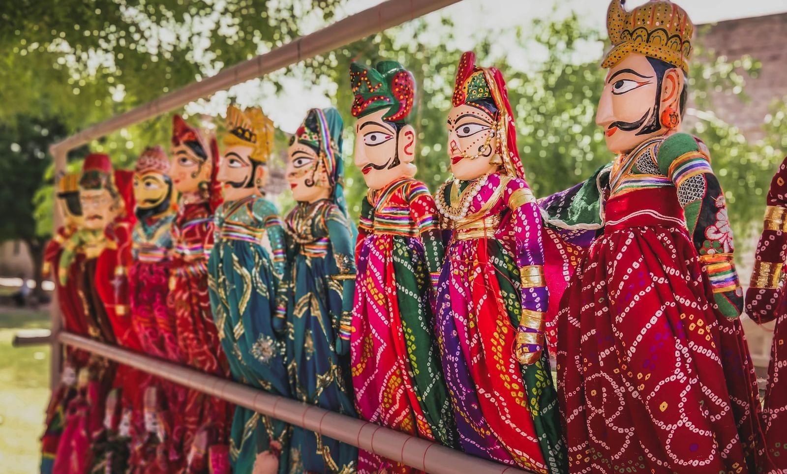An image of a puppet show with vibrant rajasthani dolls
