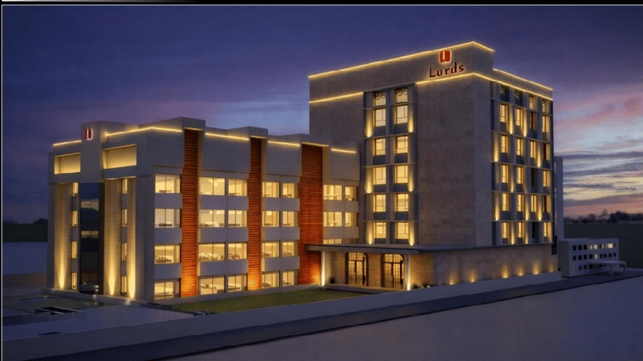 Exterior of Lords Inn Somnath illuminated beautifully at dusk, showcasing its modern architecture and vibrant facade lighting.