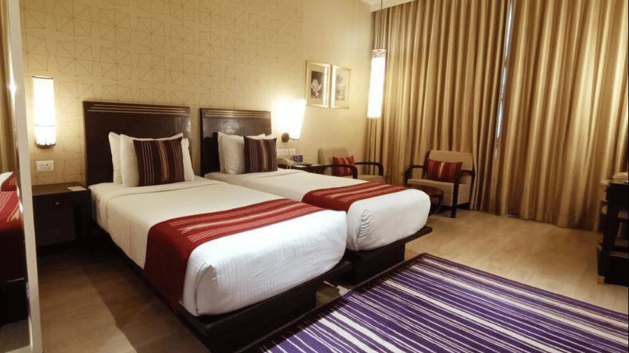 Comfortable Deluxe Twin Room at Marasa Sarovar Premiere, Tirupati with twin beds, contemporary furnishings, warm lighting, and modern amenities for a relaxing stay.