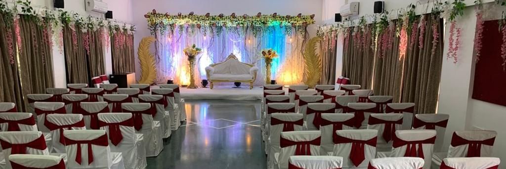 Event space at Mayur Retreat set up with decorated chairs and a view of the stage in the background.