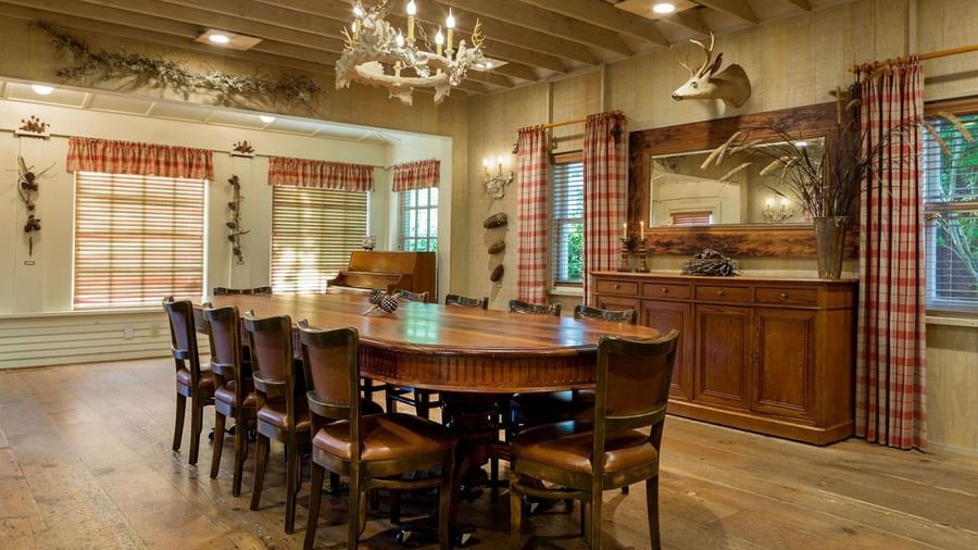 A rustic yet elegant private dining room at the Tallman Hotel with a large oval table and chandelier.