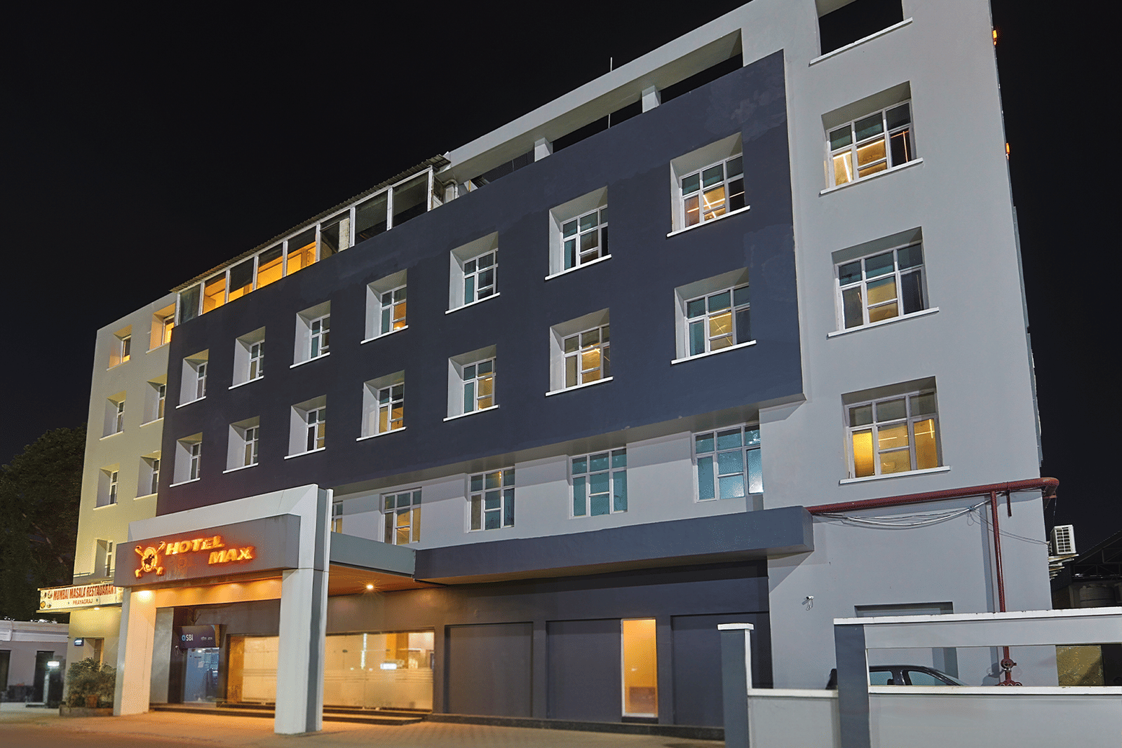 Night view of Max Hotel Prayagraj exterior with lit entrance.