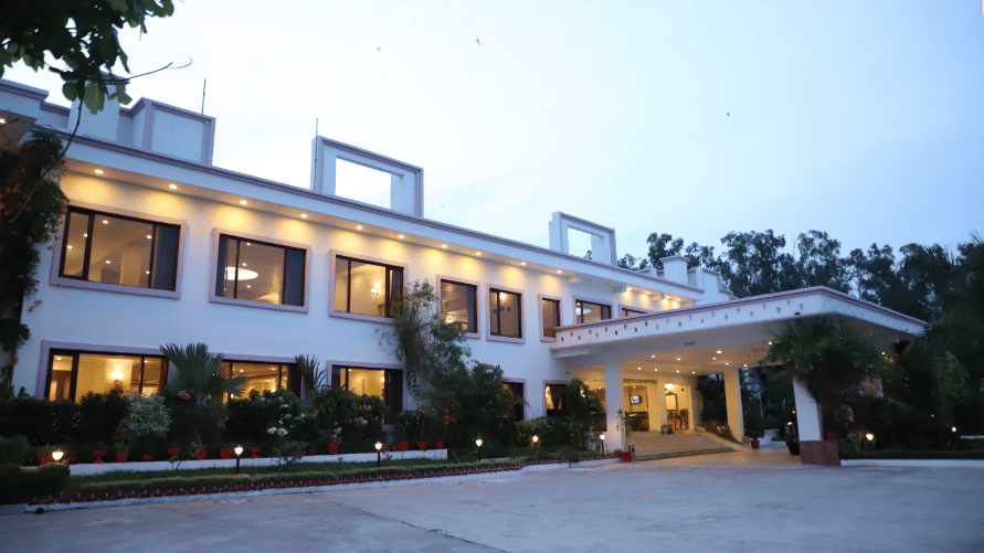 A front-facing view of the hotel building at AS Hotels, Khajuraho, during evening light.