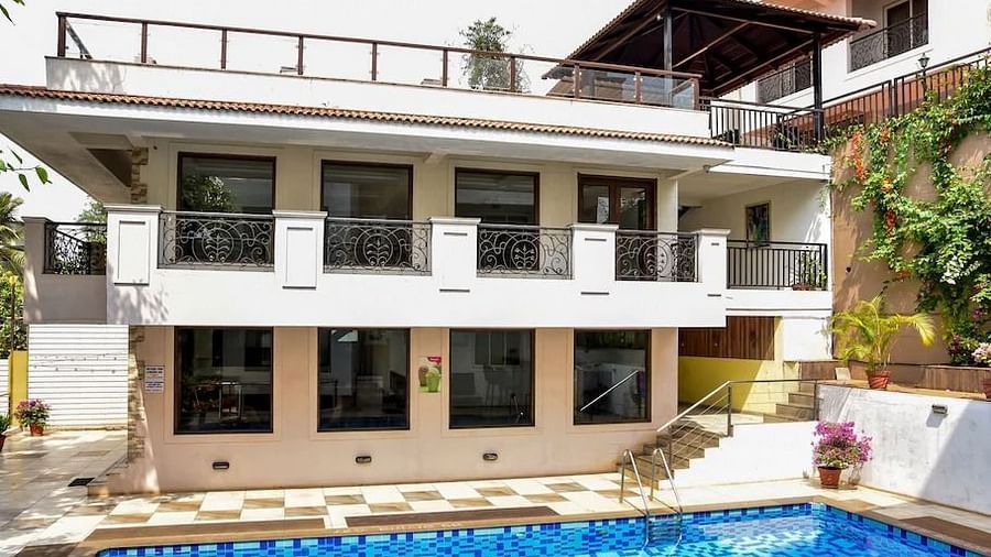 Exterior of a building with balconies overlooking a pool at La Vida Studio Inn Goa.
