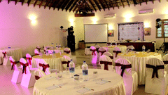 Banquet hall in Abad Turtle Beach Resort, Marari Alleppey, the best resort in Alleppey, featuring round tables and chairs covered in white table clothes