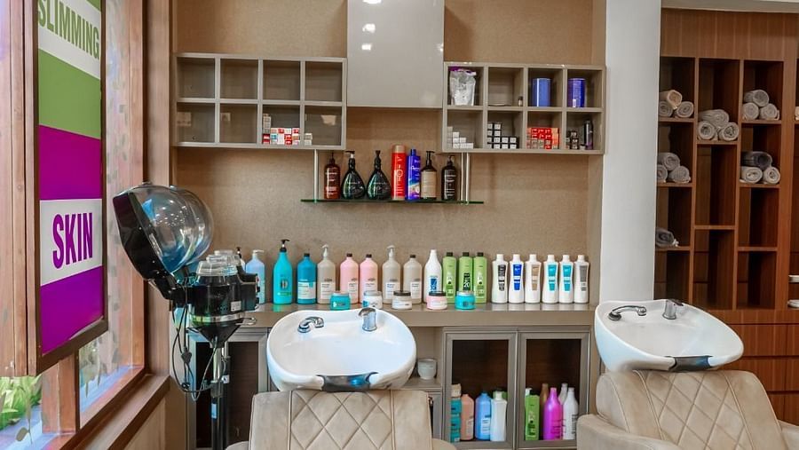 close up shot of the hair washing area with chairs for customer to sit in - IOSIS Spa & Wellness