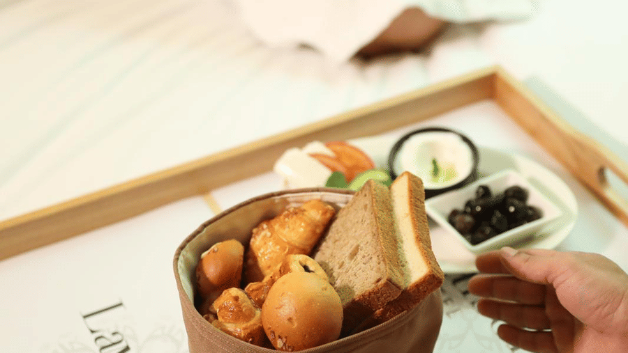 A breakfast tray with pastries being served in-room at La Maison Hotel, Doha.