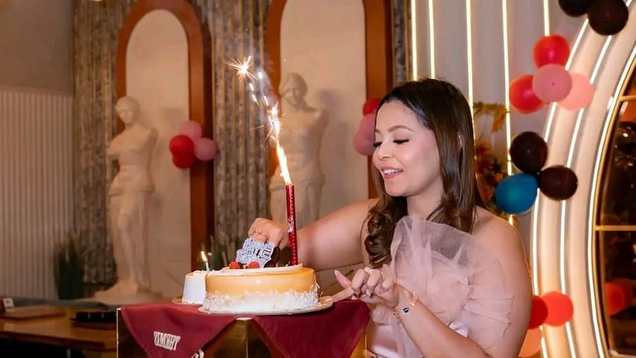 Guest cutting a cake at Themis Barbecue House, Ambala with festive decorations in the background