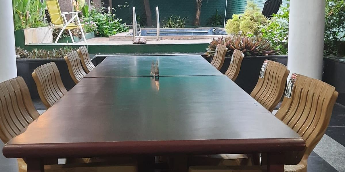 Image of a dining space with a table and chairs around it at Villa Serenity Le Sejour Pondicherry.