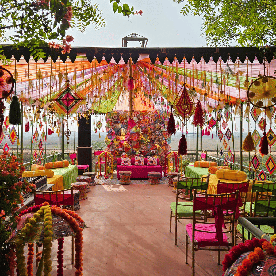 Bright and colourful mehendi or haldi ceremony décor with festive seating arrangement.