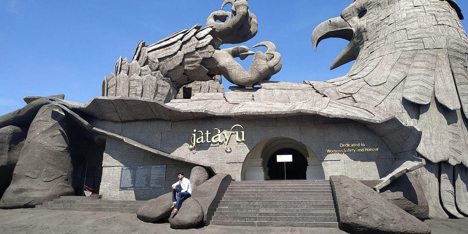 a close up shot of jatayu rock with blue sky in the background