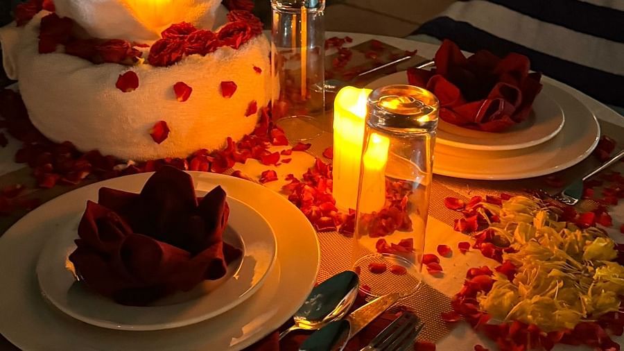 A beautifully set table with a special cake, candles, and romantic decorations for a celebration. - Sea Hills Resort, Swaraj Dweep (Havelock)