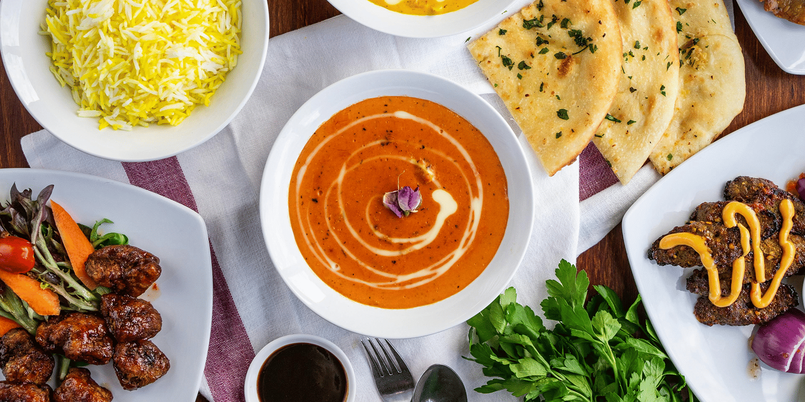 A top shot of a delicious spread of various Indian dishes served on a table.