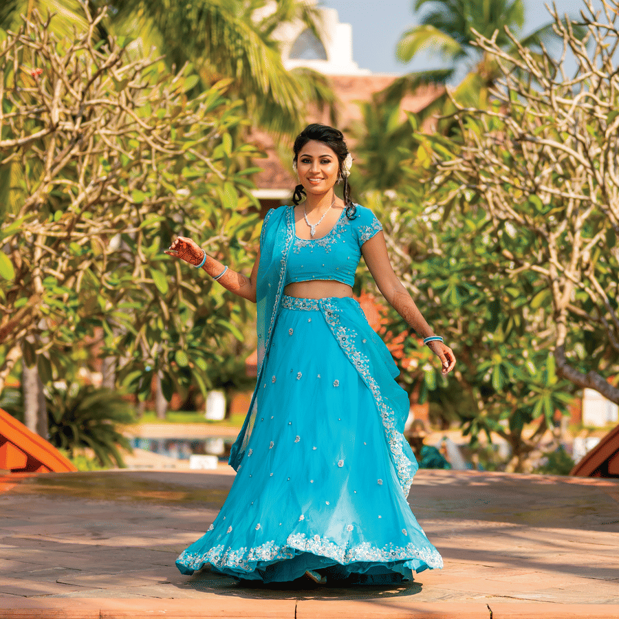 a woman posing for a picture with greenery in the background - Caravela Beach Resort Goa