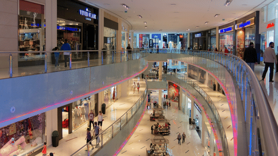 Interior view of Galle City Centre shopping mall with multi-level retail stores, open atrium, and bright ambient lighting.