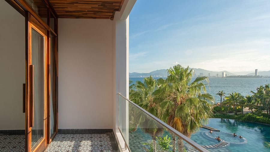 A balcony in one of the room with a sliding glass door - Alibu Resort Nha Trang