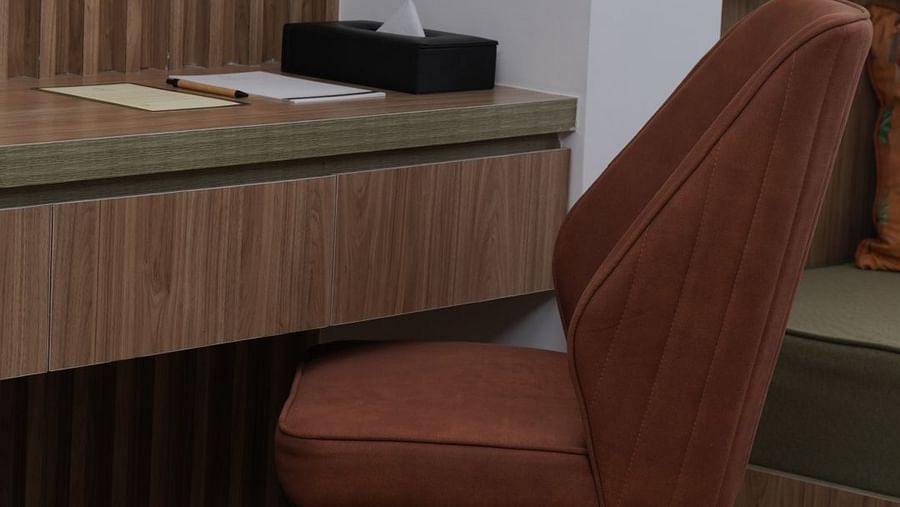 work desk and chair in one of the rooms at Triptam Hotel, Vrindavan