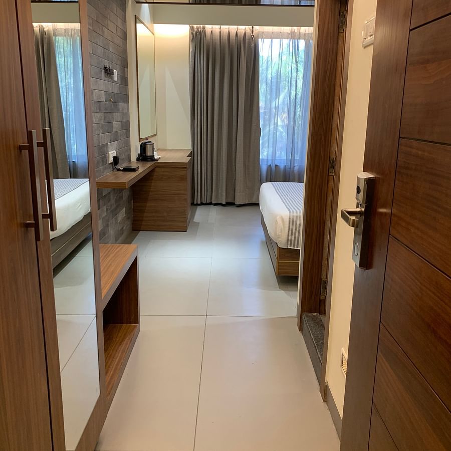 the walk through from the entrance to the bedroom of the stable facing room in Khandala - Zara's Resort